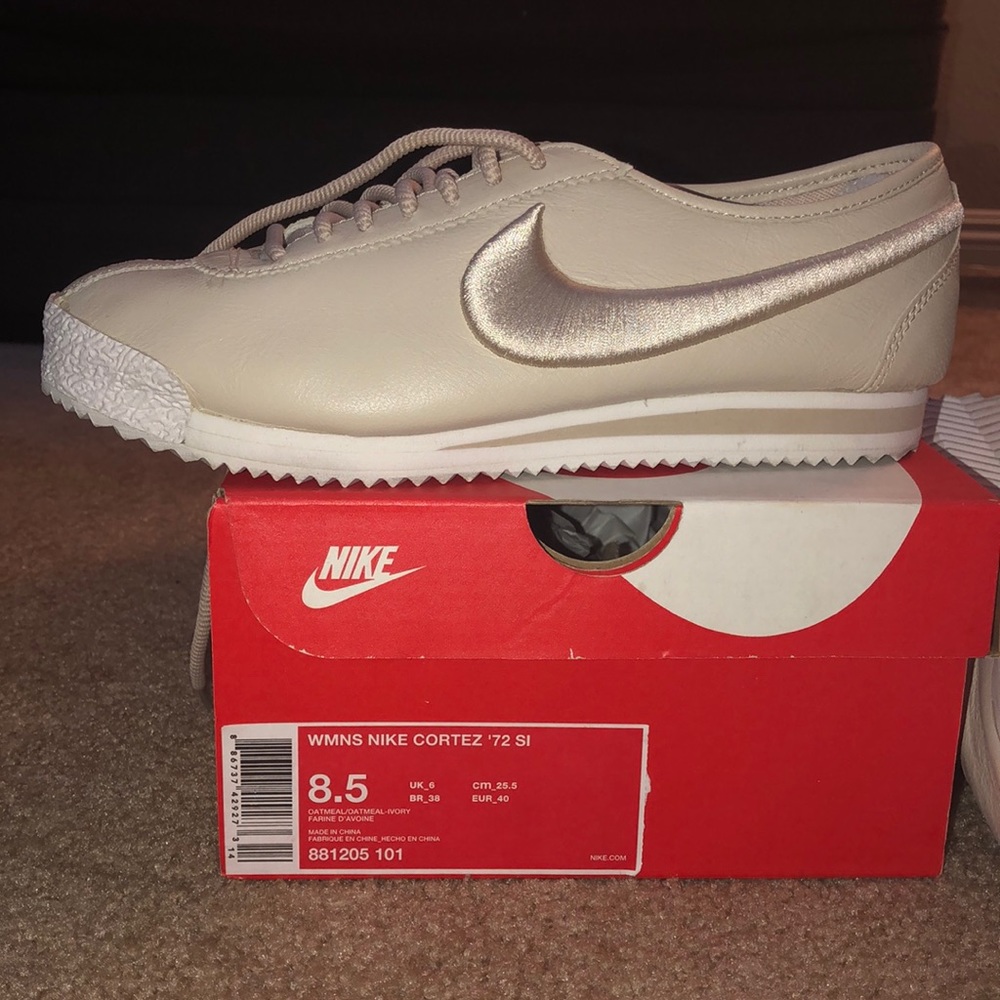 Tan and white Nike women’s Cortez